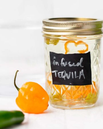 Habanero Infused Tequila adds the perfect little spicy punch to all your tequila cocktails! infused tequila | tequila | how to infuse tequila | how to infuse tequila with habanero | tequila infused with habanero jalapeno | mango habanero margarita