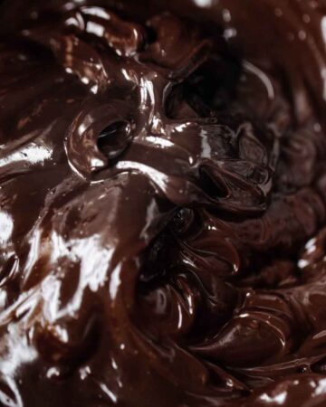 Swirls of luscious chocolate ganache up close in a bowl.