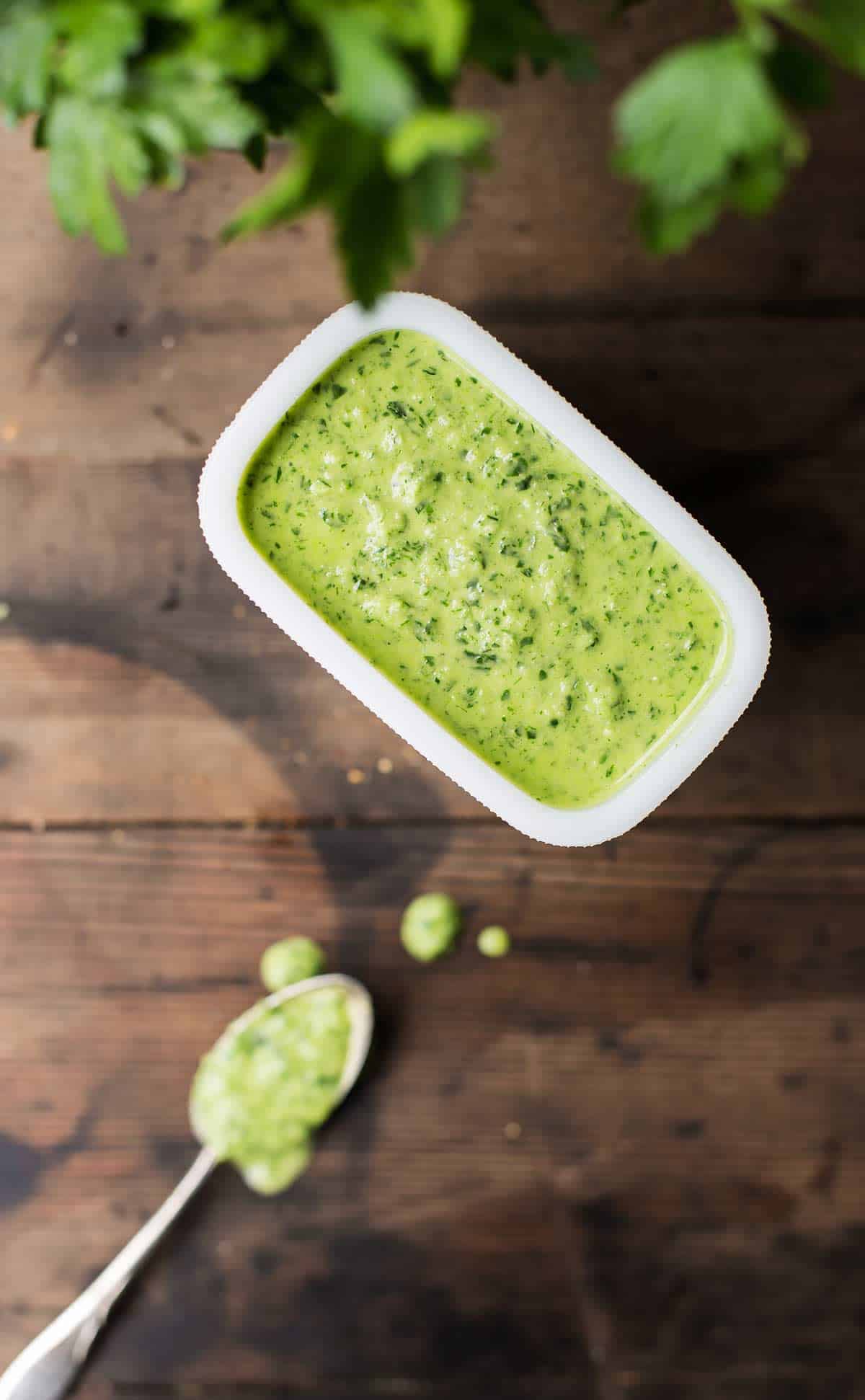 Creamy bright green chimichurri sauce with some fresh parsley