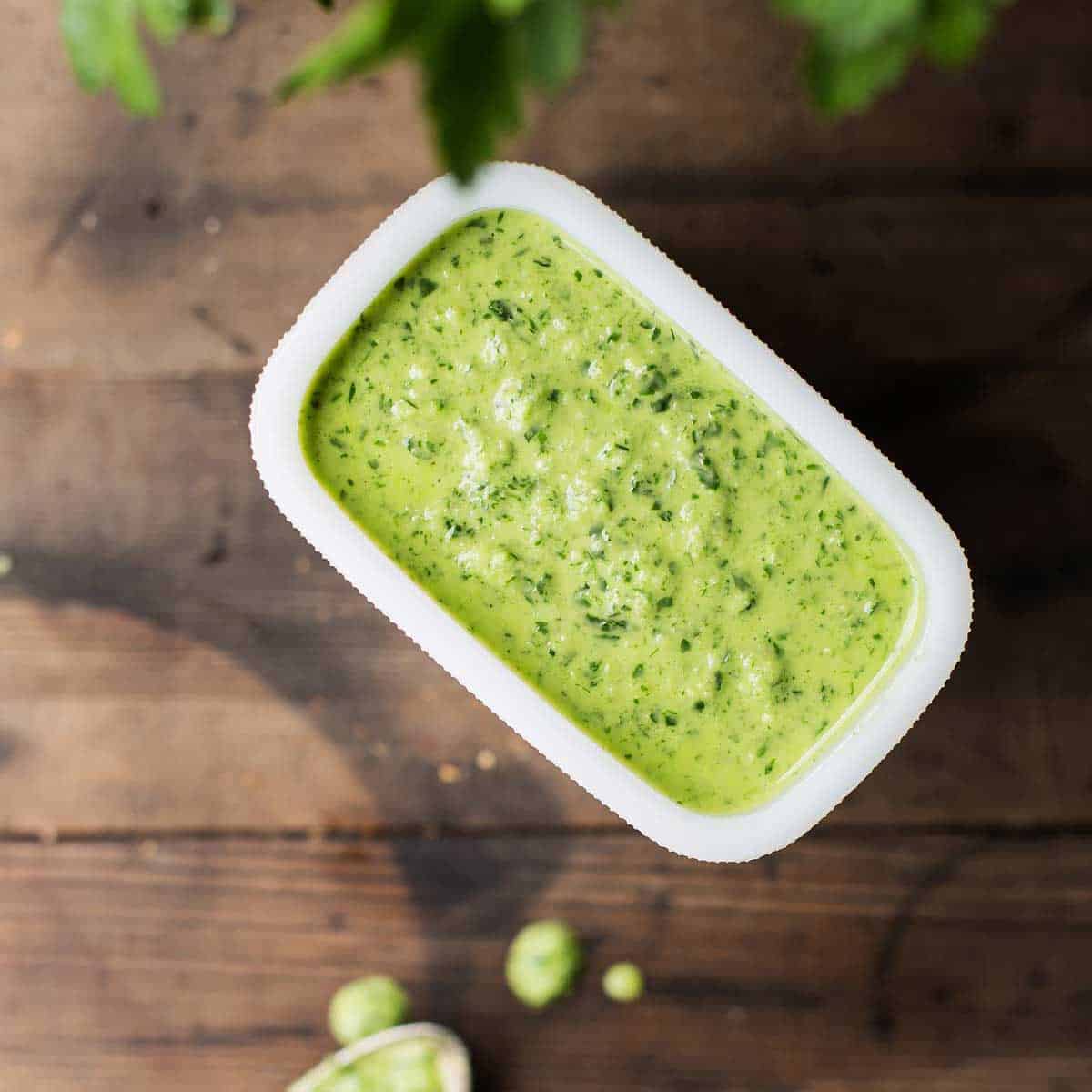 Creamy bright green chimichurri sauce with some fresh parsley