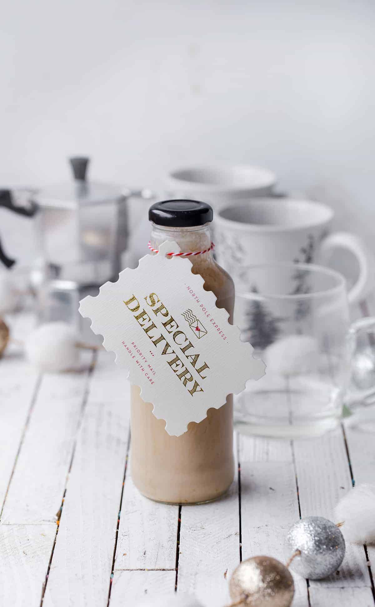 A bottle of homemade irish cream with a cute christmas gift tag.
