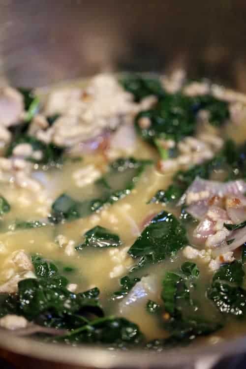 Sausage Kale Soup with White Beans is a rustic, delicious, quick and easy soup that can be on the table in less than thirty minutes! kale recipes | kale recipes soup | kale soup