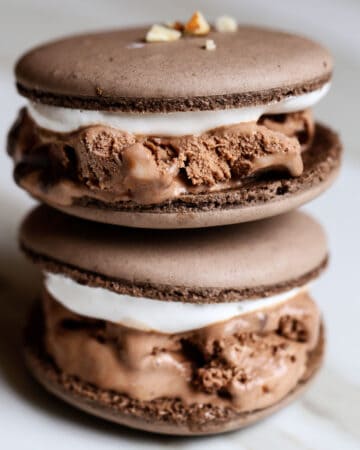 Stack of cool, creamy, chewy, crunchy rocky road chocolate macaron ice cream sandwiches.