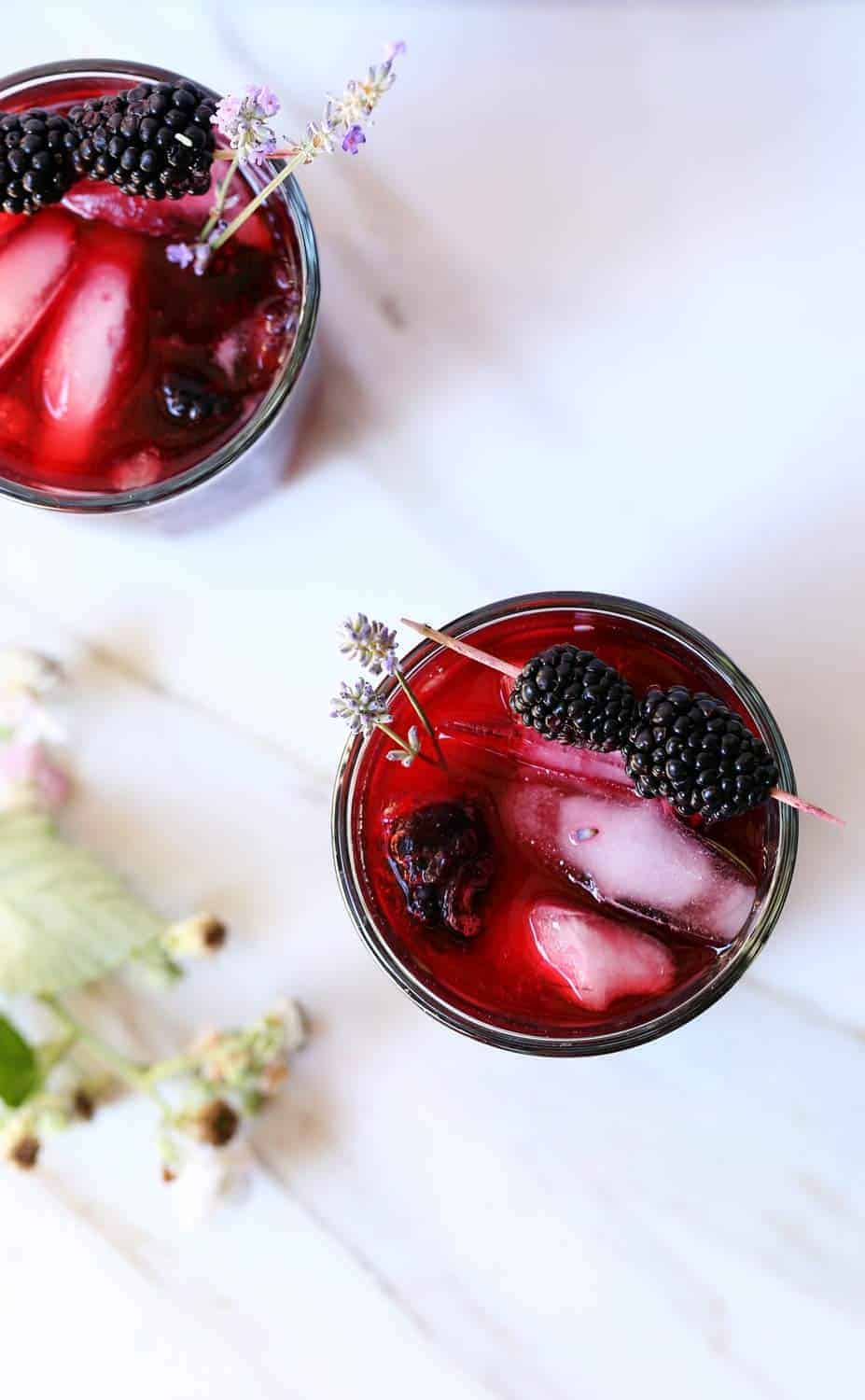 Blackberry iced tea with fresh blackberries and garnished with lavender