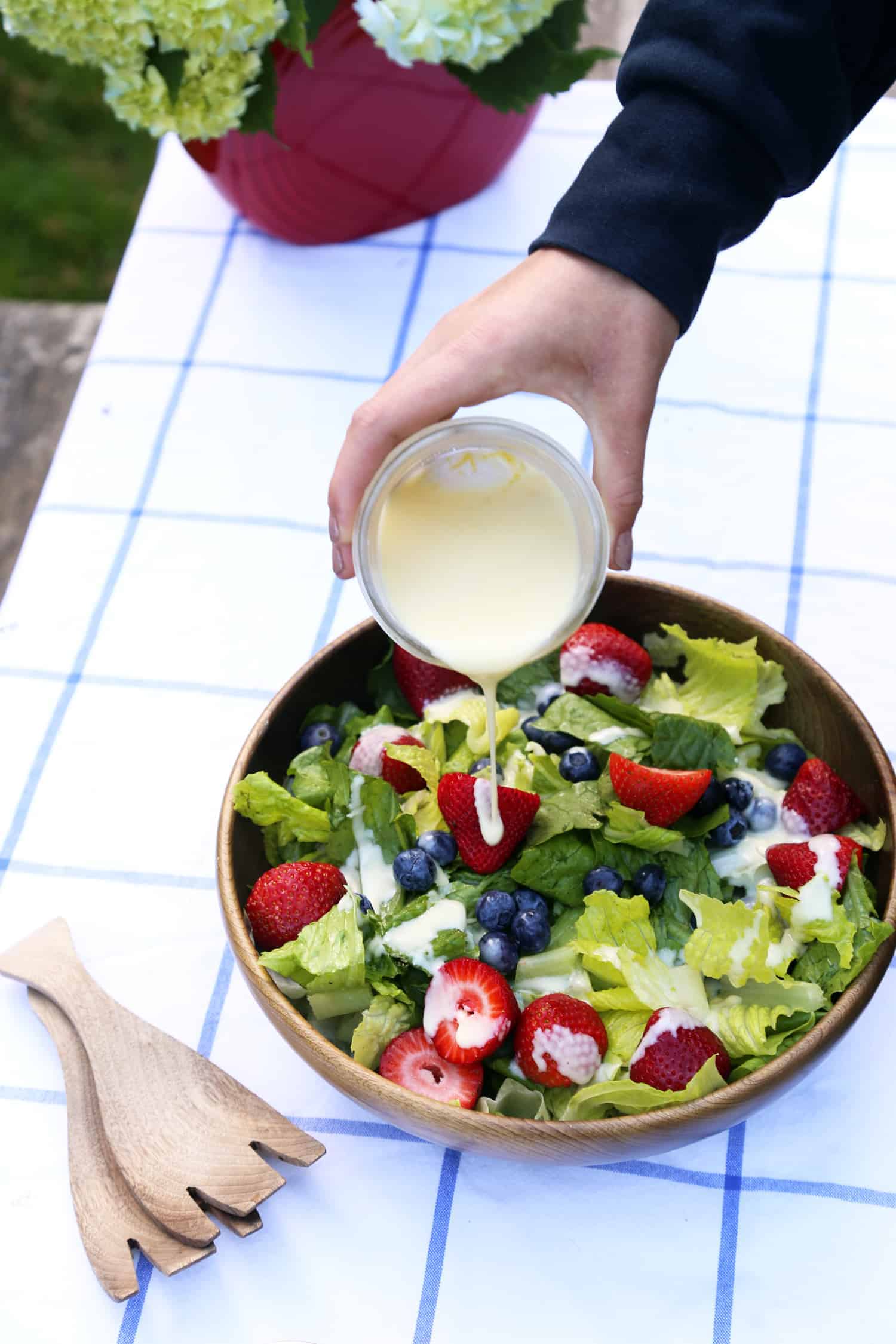 Red, White and Blue Summer Fruit Salad with Creamy Lemon Dressing is the perfect light, refreshing summer salad to bring to parties, picnics and potlucks. fruit salad recipe | strawberry salad | summer salad lemon dressing | potluck recipe | picnic salad