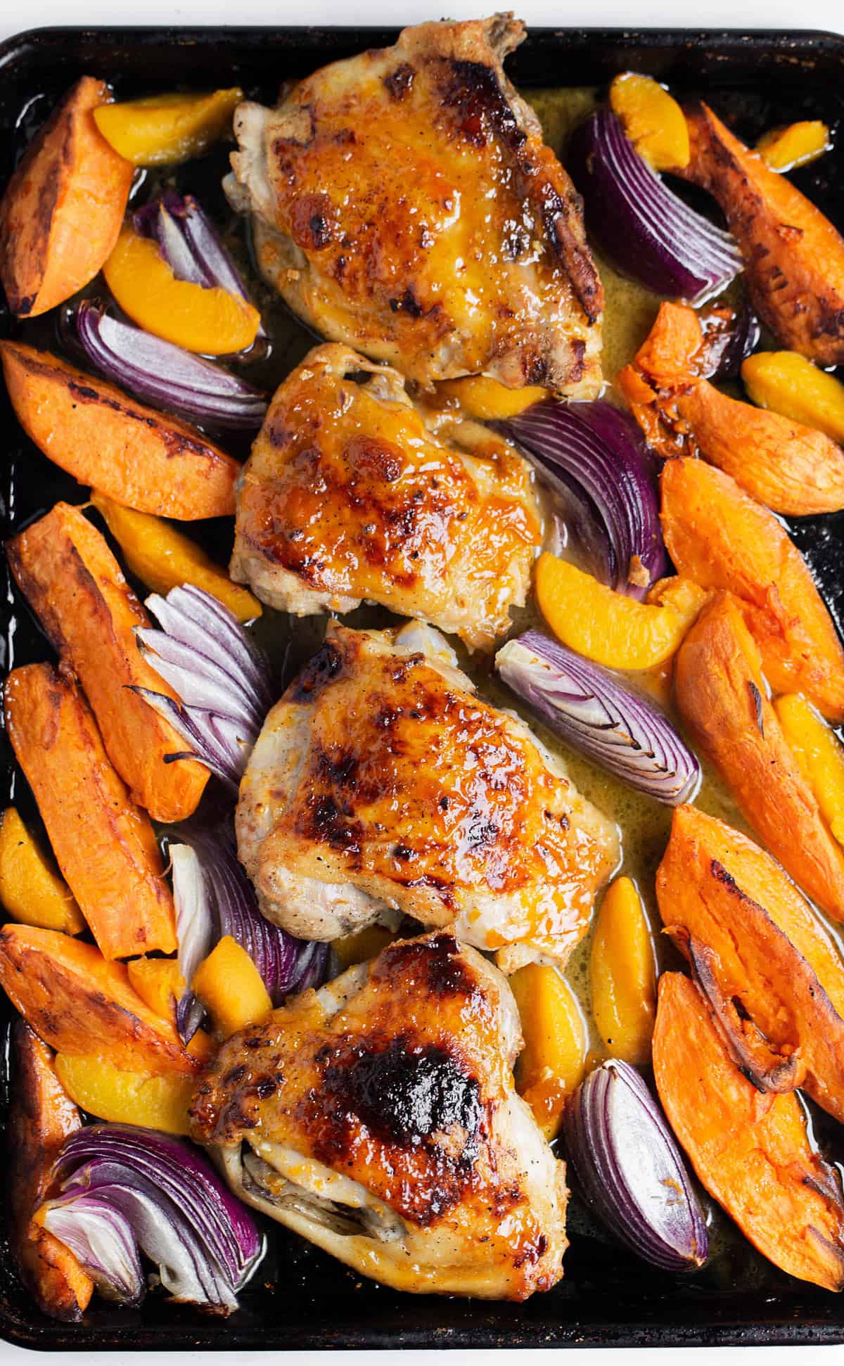 Sheet Pan Apricot Chicken and Potatoes is a quick, easy sheet pan meal that turns a few simple ingredients into an amazing meal in only 30 minutes!   baked chicken thighs | apricot chicken | sheet pan chicken recipes
