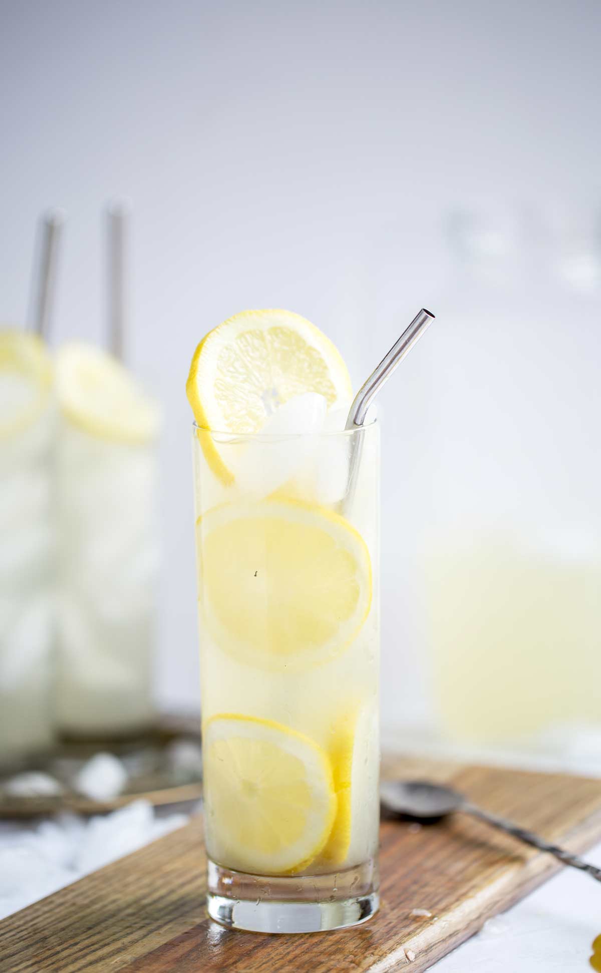 lemon slices and refreshing lemon cocktail in a tall glass