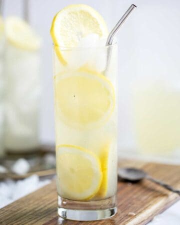 lemon slices and refreshing lemon cocktail in a tall glass