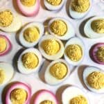 Colorful deviled eggs made from naturally dyed hard boiled eggs in a variety of different colors.