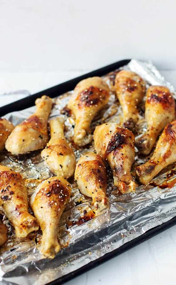 Baked Honey Ginger Chicken is an easy weeknight dinner recipe with tender meat, crispy skin and big flavor! baked chicken | legs breast thigh tenders tenderloins | recipes | honey baked chicken | soy | garlic | glazed | easy chicken recipes for dinner | gluten free | baked chicken for a crowd