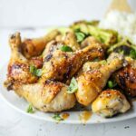 Baked Honey Ginger Chicken is an easy weeknight dinner recipe with tender meat, crispy skin and big flavor! baked chicken | legs breast thigh tenders tenderloins | recipes | honey baked chicken | soy | garlic | glazed | easy chicken recipes for dinner | gluten free | baked chicken for a crowd