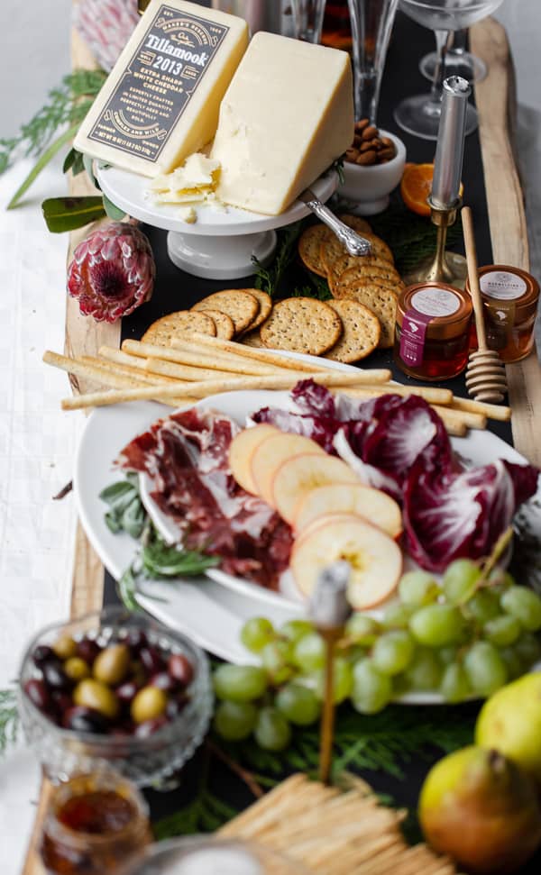 Simple to put together, this Upscale Charcuterie Grazing Table is sure to WOW guests over the holidays. Or any time of year!  what to pair with aged cheddar | appetizers | canape ideas | fancy | christmas | new years eve | champagne and cheese #Tillamook #dairydoneright #ad @tillamook