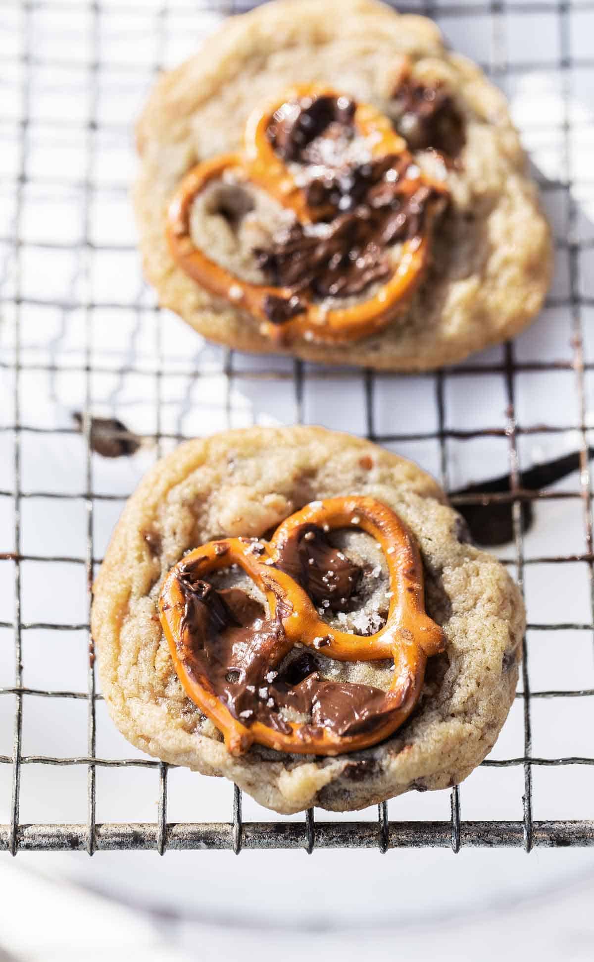 Chocolate chip pretzel cookie with whole pretzel and melted chocolate on the top.