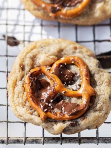 Chocolate chip pretzel cookie with whole pretzel and melted chocolate on the top.