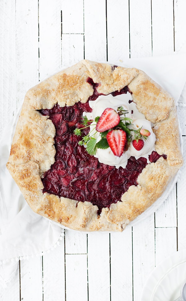 An easy -to-make impressive dessert with crisp pastry and jammy fruit filling Lemon Curd Wild Strawberry Galette is perfectly suited for summertime travel! Strawberry galette | wild strawberry galette crostata recipe | rustic pie | galette dough pie crust recipe | strawberry recipes | lemon curd | strawberry lemon