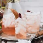 Pink sumac lemonade garnished with sumac berries and leavese