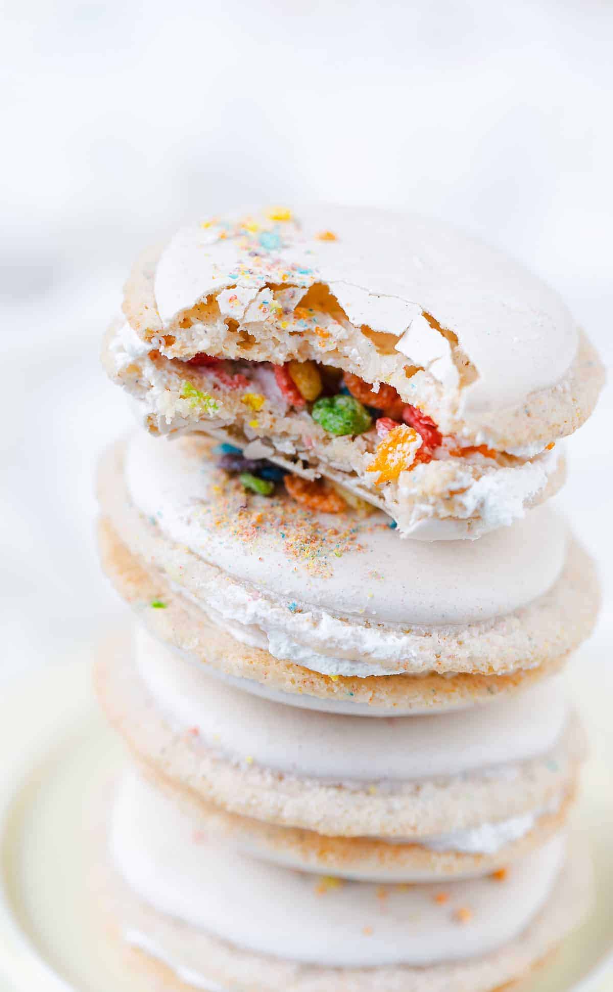 Fruity PEBBLES™ Cereal Milk Macarons are a perfect classic vanilla macaron shell with colorful flecks of tropical fruit flavored cereal and finished with a cereal milk cream macaron filling. Fruity PEBBLES™ Cereal milk macarons recipe | macarons filling ingredients | Fruity PEBBLES™ cookies | gluten-free baking #recipe #glutenfree #cookies #ad