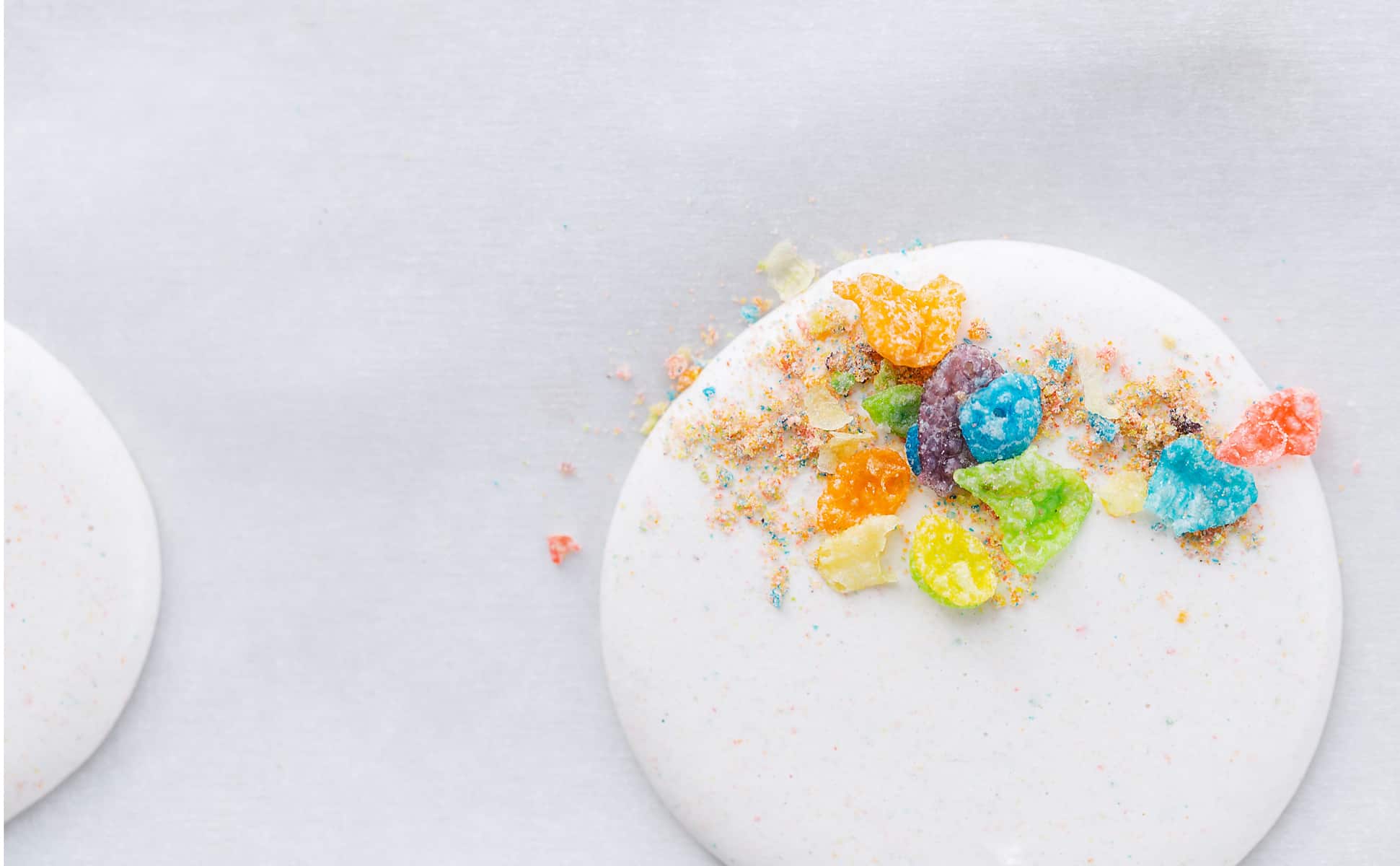 Cereal milk macaron shells topped with Fruity PEBBLES™ Cereal