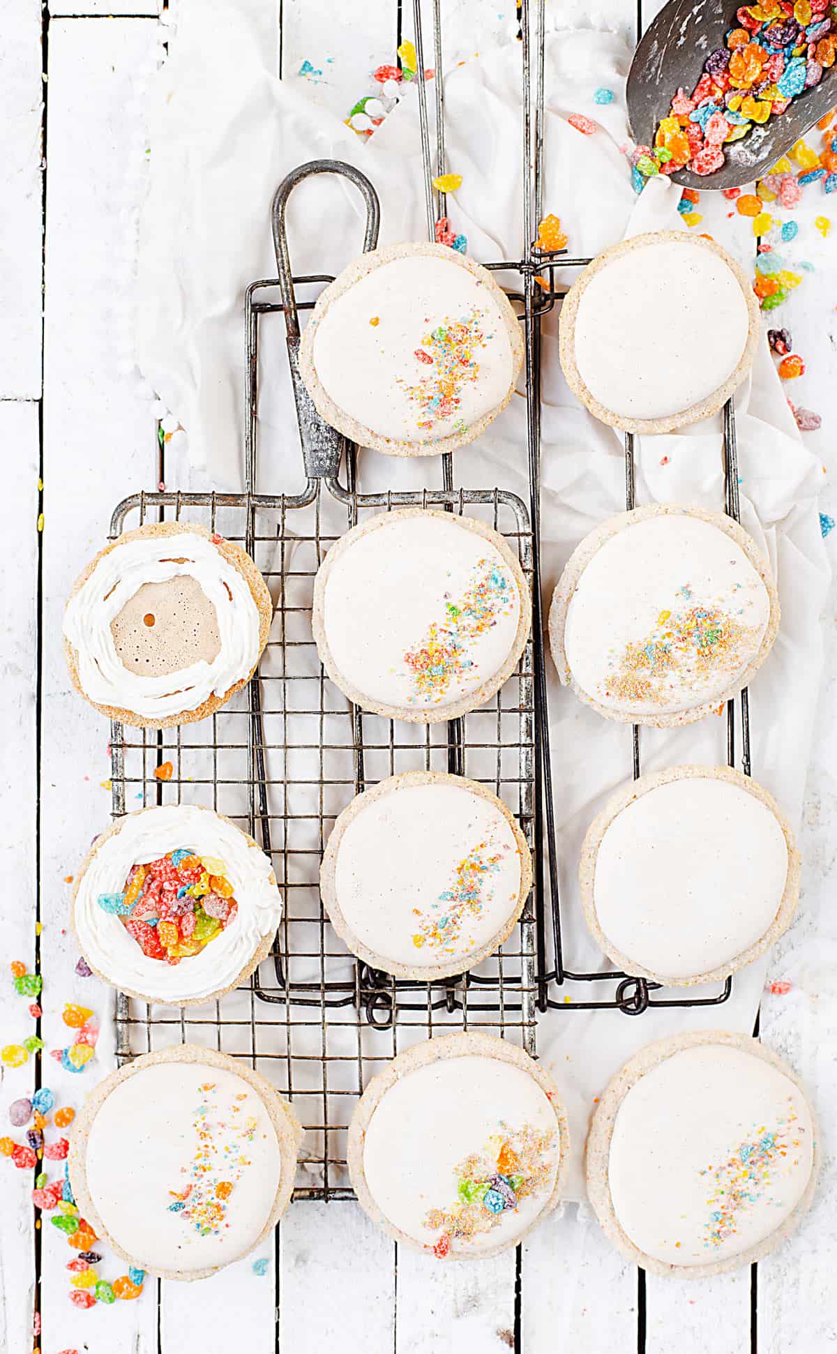 Fruity PEBBLES™ Cereal Milk Macarons being filled with cereal milk cream and Fruity PEBBLES™ 