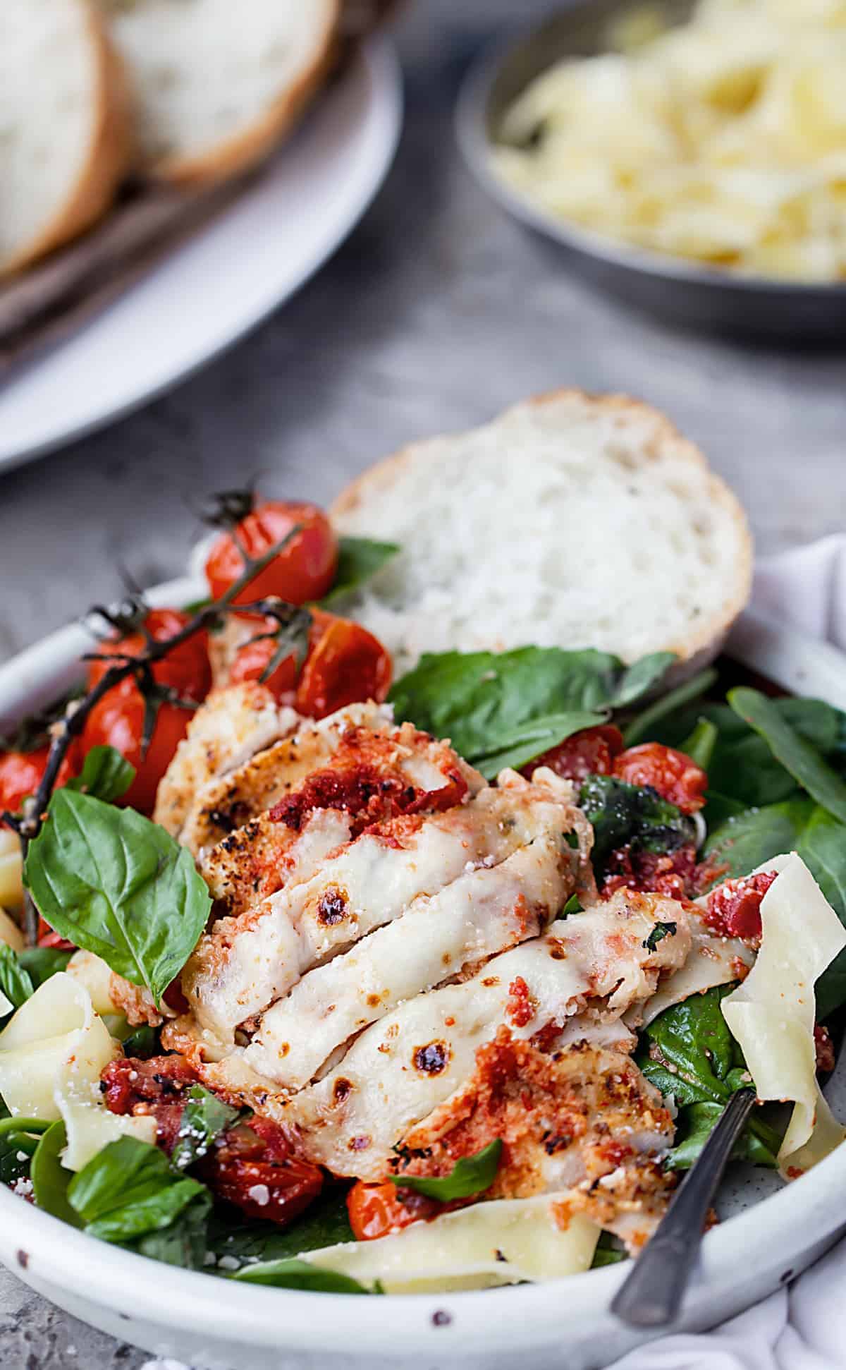 Easy One – Tray Baked Chicken Parmesan with Roasted Tomato Sauce is full of garlic, cheese, fresh herbs, and tomato sauce with bursted tomatoes and deep rich flavor. | easy baked chicken parmesan recipe | parmesan crusted tray bake chicken with lemon, garlic, pasta and spinach recipe #sponsored by @muirglen @thefeedfeed #MyMuirGlen #feedfeed