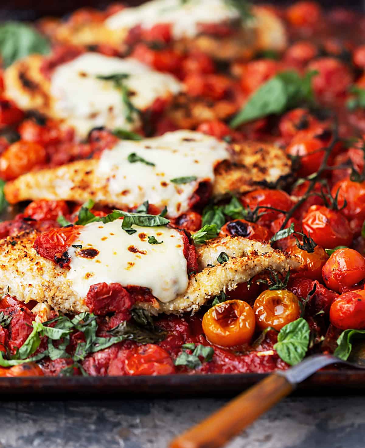 Easy One – Tray Baked Chicken Parmesan with Roasted Tomato Sauce is full of garlic, cheese, fresh herbs, and tomato sauce with bursted tomatoes and deep rich flavor. | easy baked chicken parmesan recipe | parmesan crusted tray bake chicken with lemon, garlic, pasta and spinach recipe #sponsored by @muirglen @thefeedfeed #MyMuirGlen #feedfeed