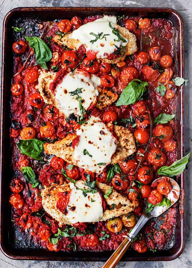 Easy One – Tray Baked Chicken Parmesan with Roasted Tomato Sauce is full of garlic, cheese, fresh herbs, and tomato sauce with bursted tomatoes and deep rich flavor. | easy baked chicken parmesan recipe | parmesan crusted tray bake chicken with lemon, garlic, pasta and spinach recipe #sponsored by @muirglen @thefeedfeed #MyMuirGlen #feedfeed