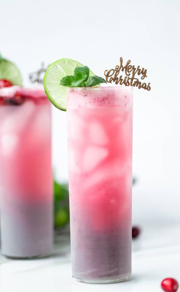The Jolly Ole  Christmas Cocktail is festive without being over-the-top. Light and fruity with just the perfect amount of red and green holiday cheer! christmas cocktail recipes | cranberry mint cocktail | vodka cocktails | holiday drink ideas 