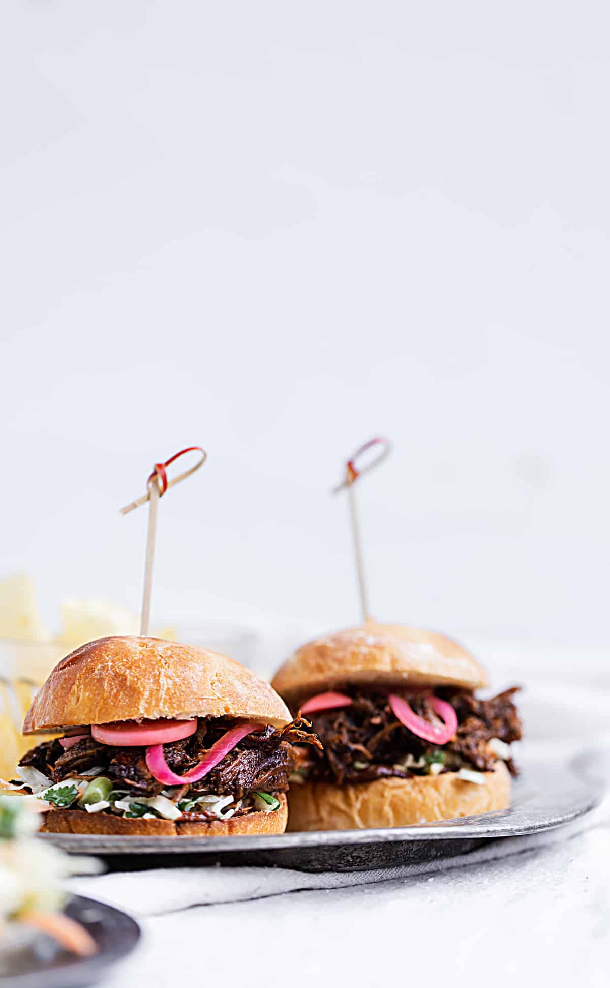 Seasoned with cocoa chili dry rub, braised until fall-apart tender and crispy, bathed in chocolate chili barbecue sauce and piled high with cilantro lime coleslaw and quick pickled onions and radishes