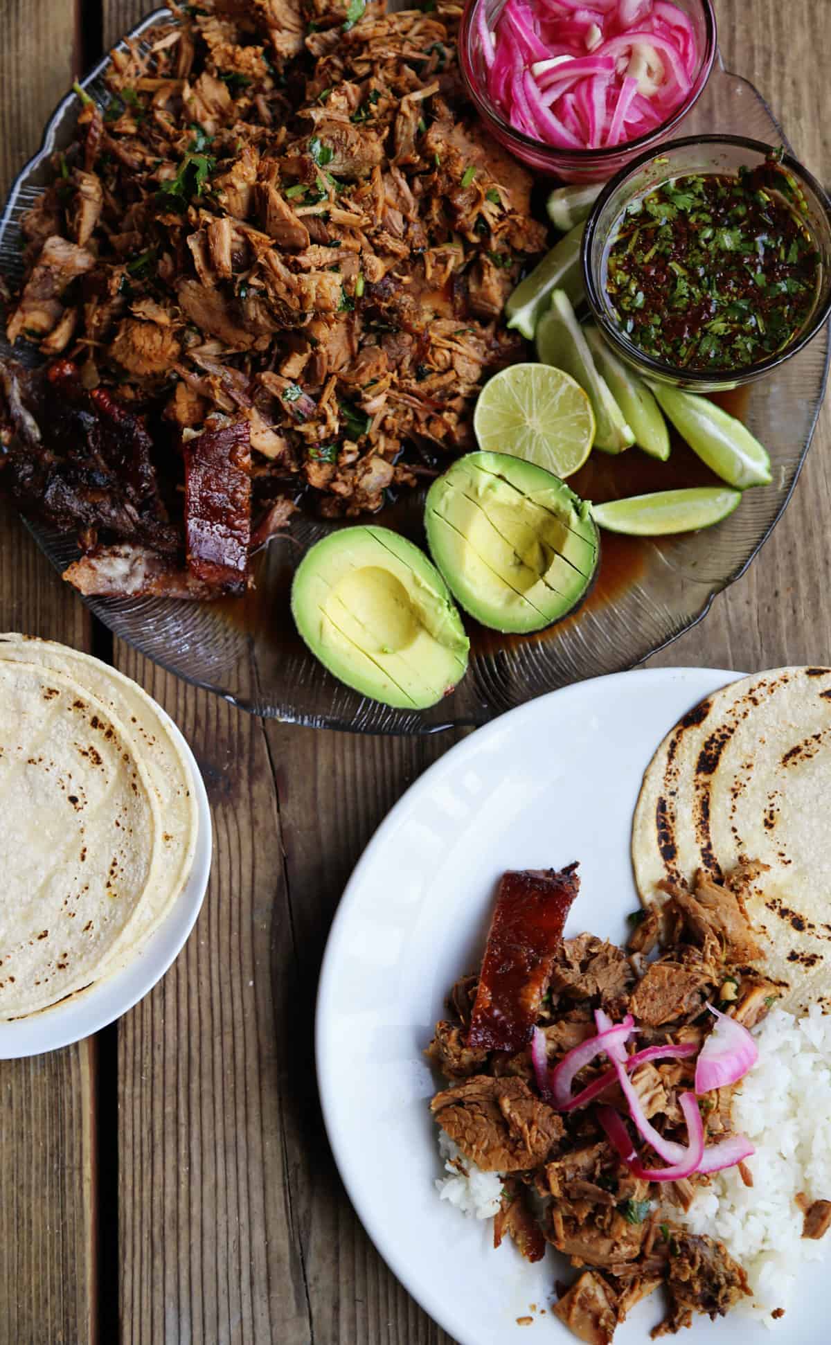 A platter of pork roast shredded into a succulent filling for tacos. A delicious pork taco recipe!