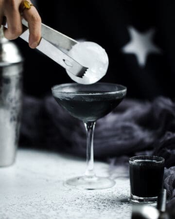 adding sphere ice to black cocktail