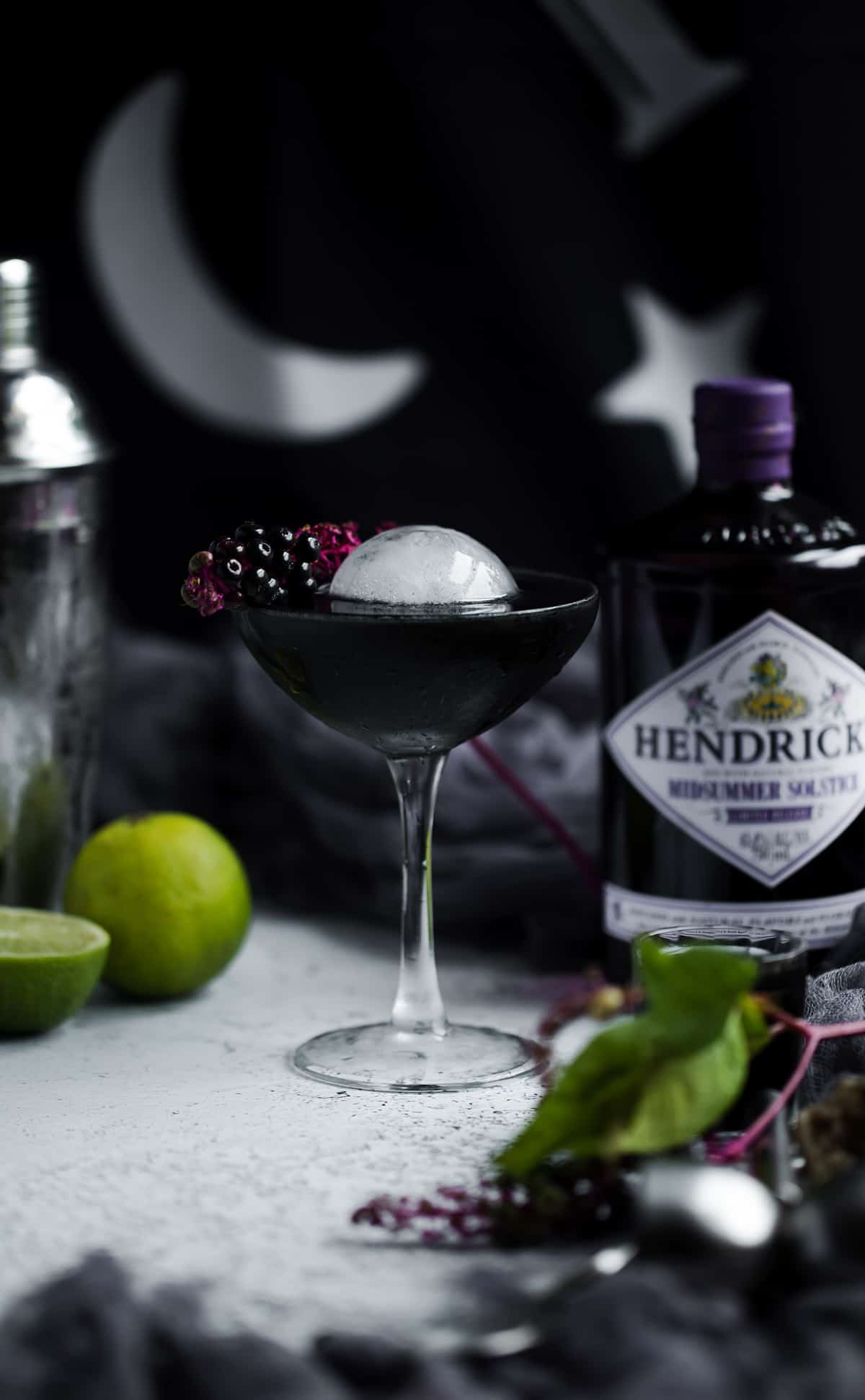 Black halloween cocktail recipe with gin and sphere ice