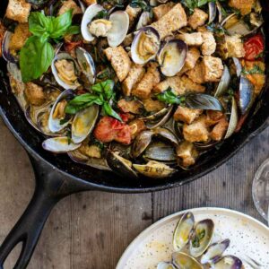 Caprese Clams are a delicious steamed clams recipe with manila clams, bursting tomatoes, garlic and thick cut croutons in a luscious basil, lemon white wine sauce. steamed clams | clams recipe | manila clams | steam clams recipe | how to steam clams