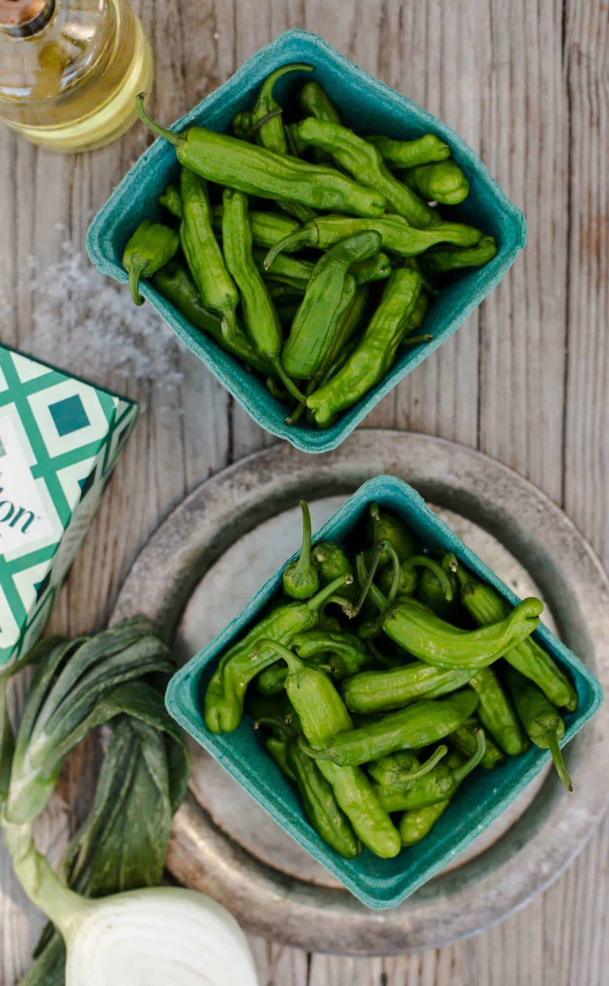 Blistered Shishito Peppers with dipping sauce is a delicious easy appetizer recipe that can be cooked in a cast iron on the stove, grilled on the bbq, baked in the oven and even made in the air fryer. shishito peppers | shishito peppers recipe | japanese peppers