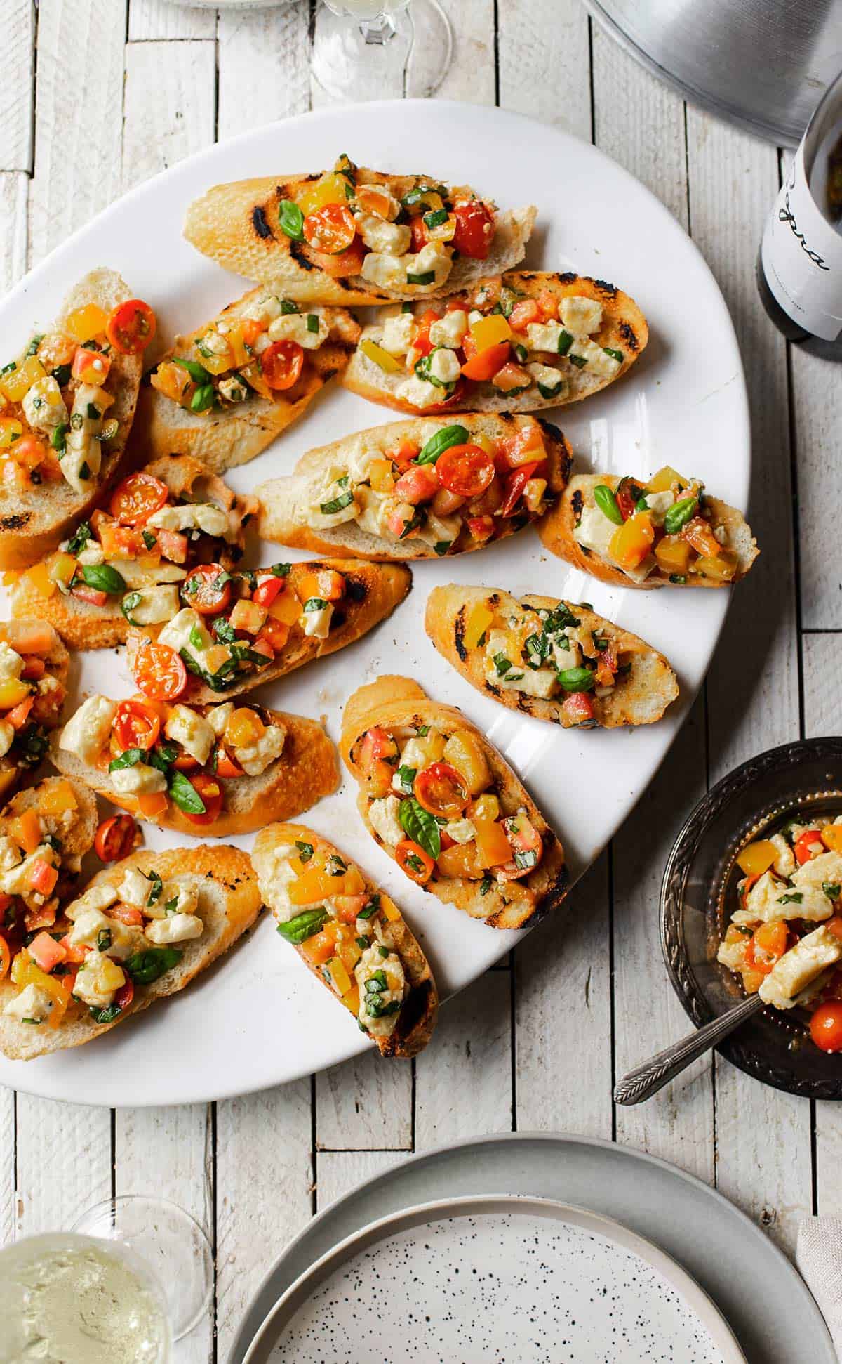 Tomato Bruschetta with Cheese is a delicious Italian antipasto recipe with cherry tomatoes, heirloom tomatoes, squeaky cheese, garlic and basil. bruschetta recipe | tomato bruschetta | easy bruschetta tomate 