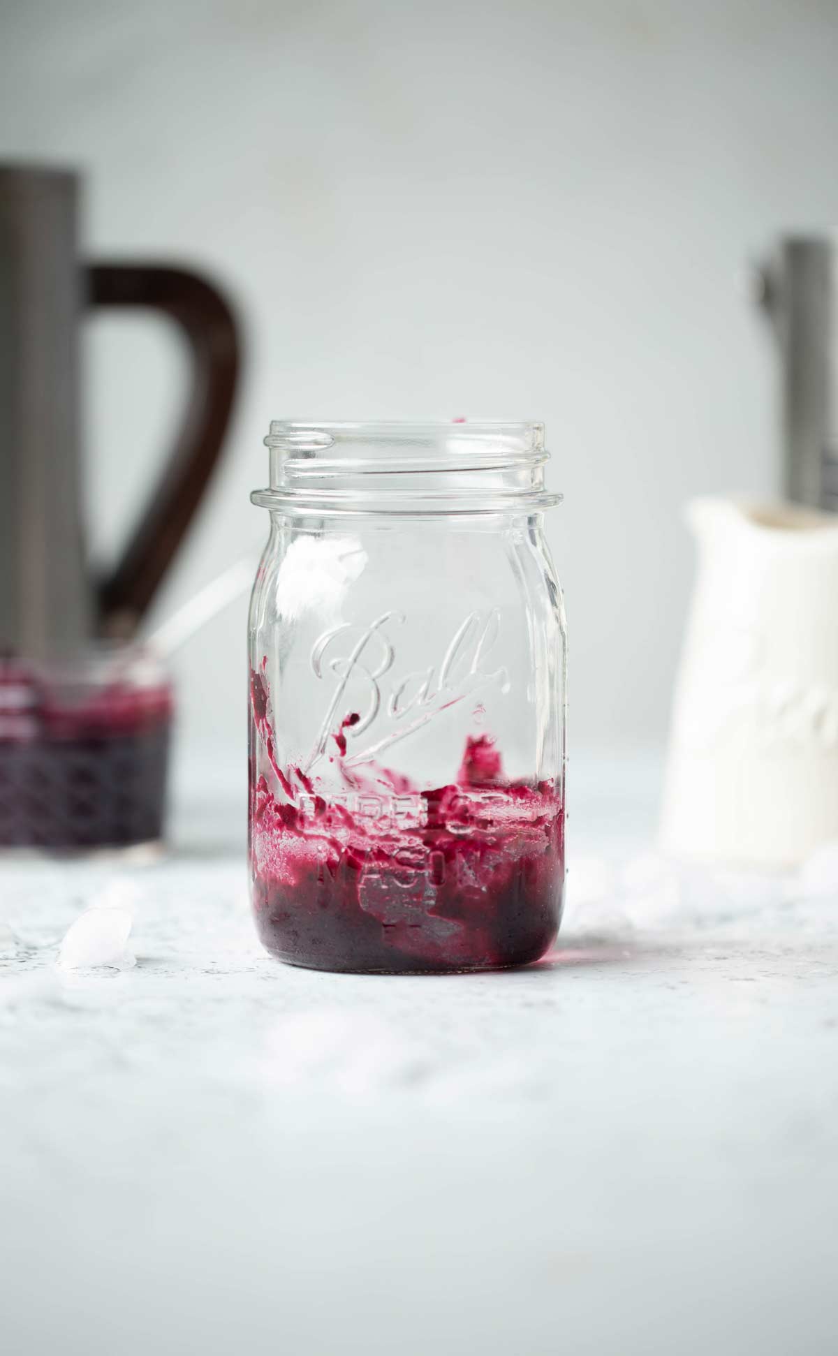 Mason jar with a layer of blueberry puree swirled around the bottom.