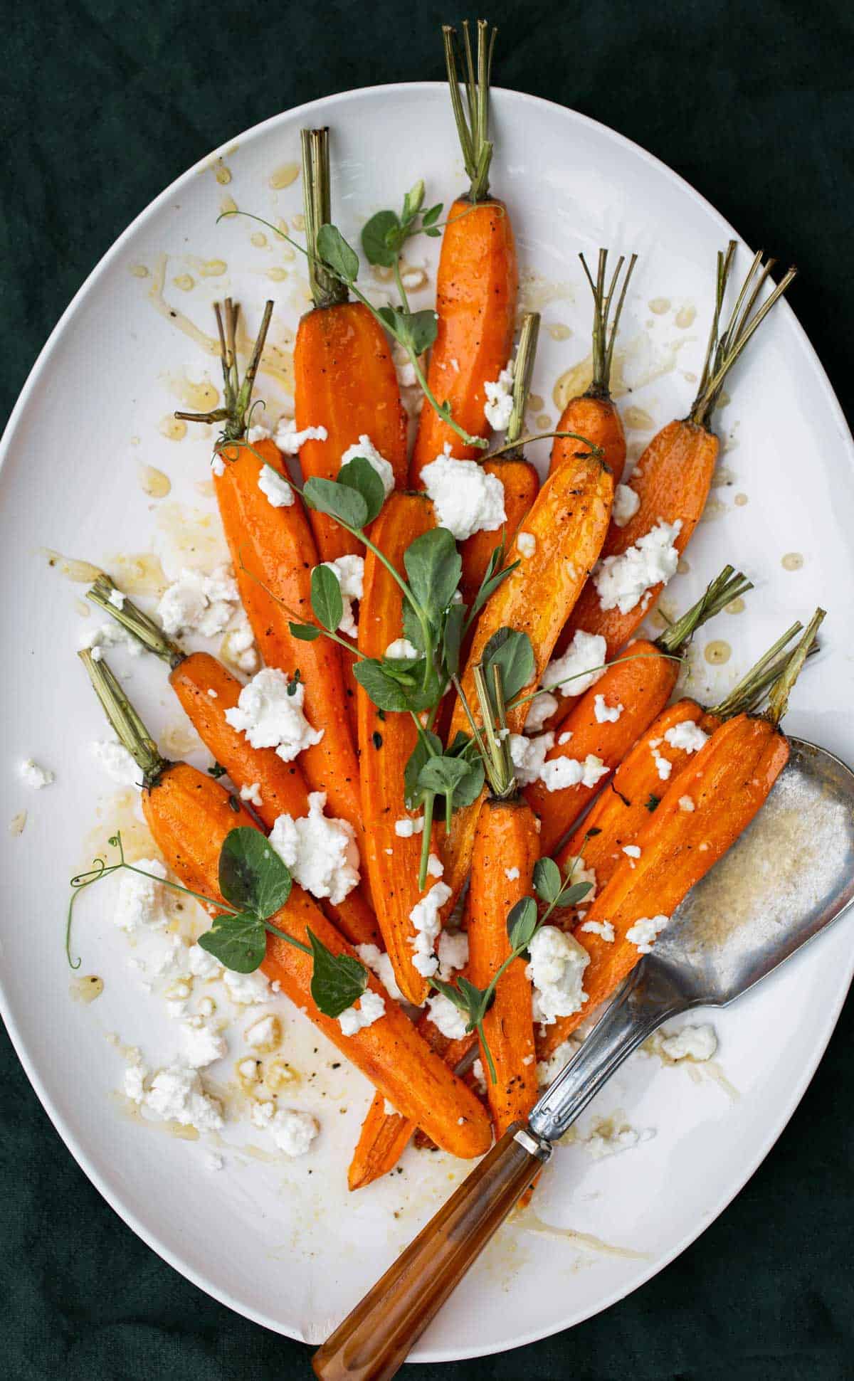 Hot Honey Roasted Carrots with goat cheese, thyme and hot honey agrodolce are perfect to serve with salmon, steak, ham, turkey and more! roasted carrots | baked carrots with honey | roasted root vegetables  hot honey recipe 