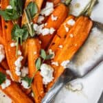 Hot Honey Roasted Carrots with goat cheese, thyme and hot honey agrodolce are perfect to serve with salmon, steak, ham, turkey and more! roasted carrots | baked carrots with honey | roasted root vegetables hot honey recipe