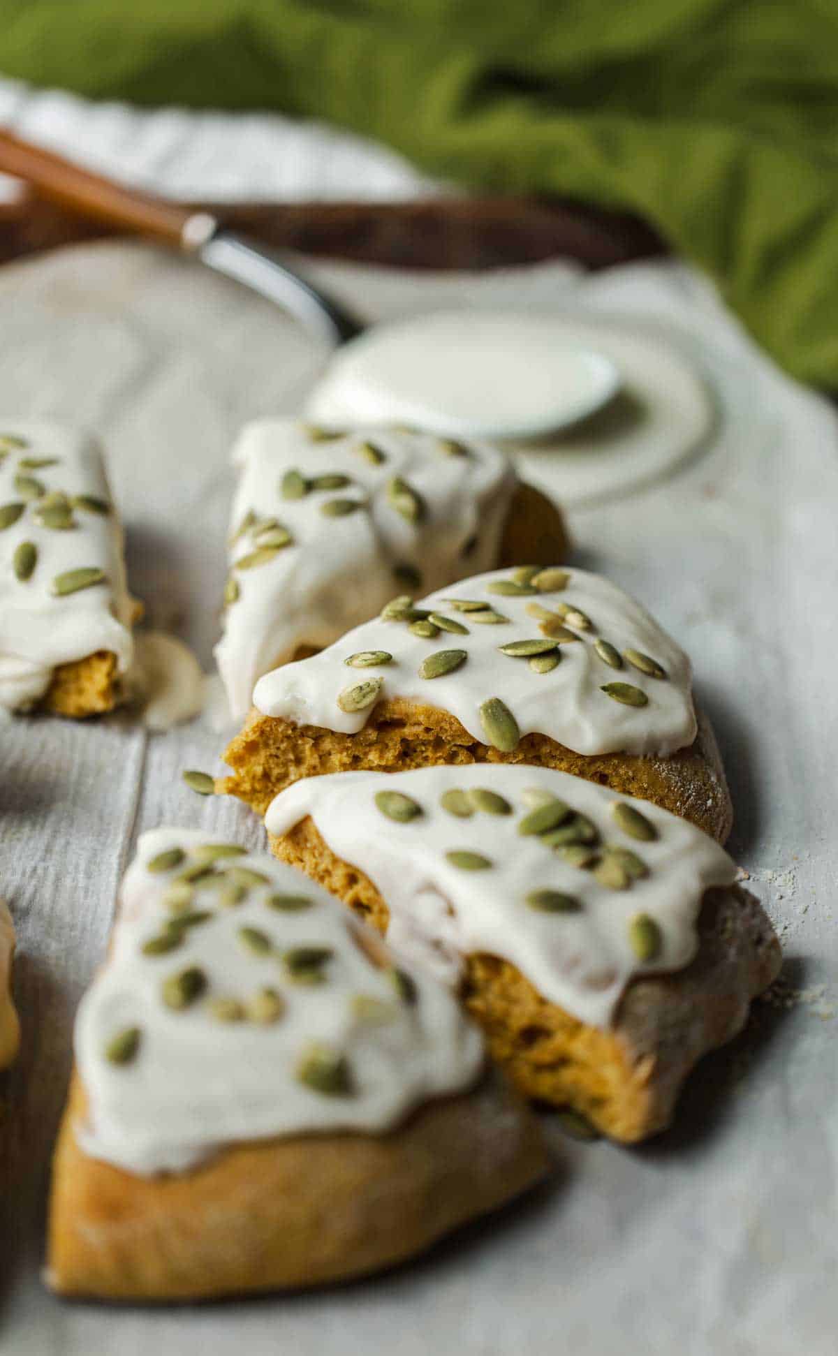 Pumpkin scones with glaze and pumpkin seeds after being glazed.