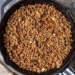 Ground beef taco filling cooked in a cast iron skillet.