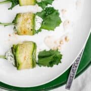 Ricotta stuffed zucchini roll ups recipe served on a platter